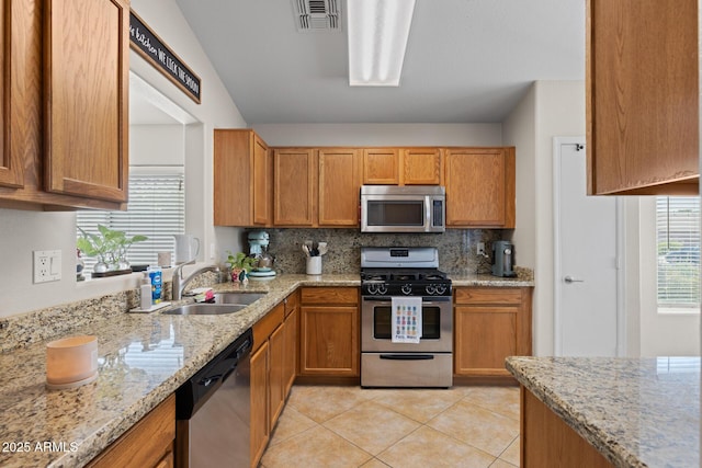 3905 E Derringer Way, Gilbert, AZ 85297 - kitchen featuring stainless steel appliances, light tile patterned flooring, decorative backsplash, and light stone counters