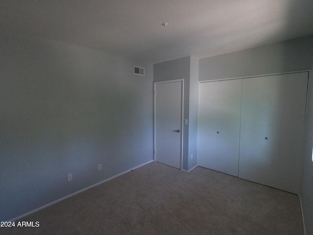 unfurnished bedroom featuring a closet and carpet floors