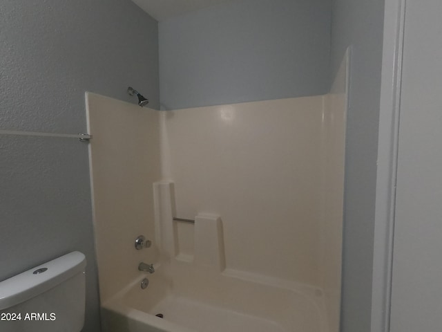 bathroom with shower / bathing tub combination and toilet