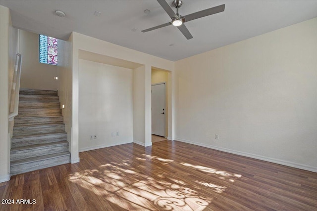 empty room with dark wood-type flooring and ceiling fan