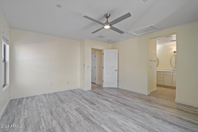 unfurnished bedroom featuring ceiling fan, light hardwood / wood-style floors, and ensuite bath