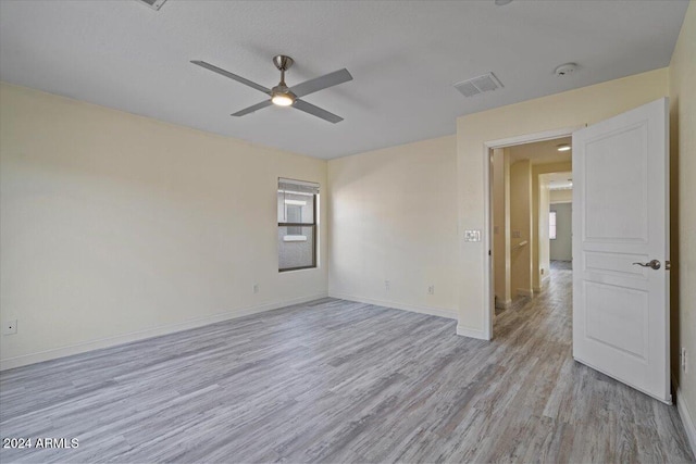 unfurnished room with ceiling fan and light hardwood / wood-style floors