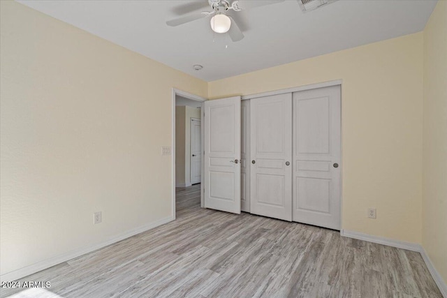 unfurnished bedroom with ceiling fan, a closet, and light hardwood / wood-style floors