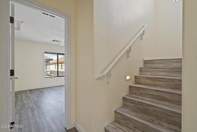 stairway featuring hardwood / wood-style floors