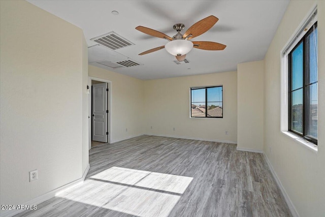 spare room featuring ceiling fan and light hardwood / wood-style floors