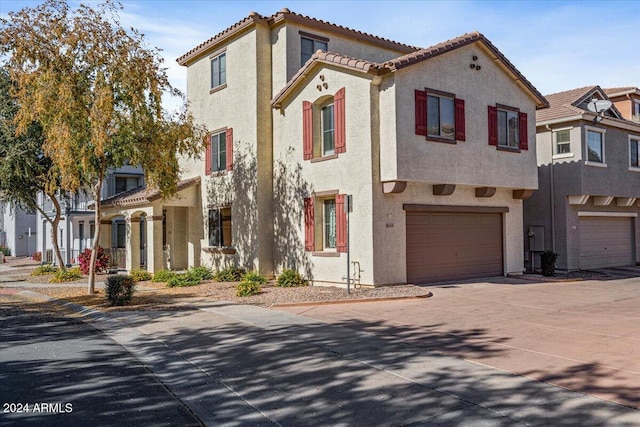 mediterranean / spanish home with a garage