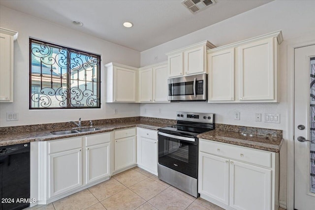 kitchen featuring sink, stainless steel appliances, and white cabinetry