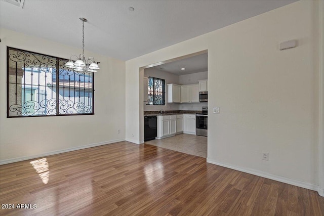 interior space with sink, a chandelier, and light hardwood / wood-style flooring