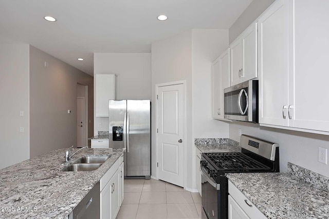 kitchen with recessed lighting, a sink, appliances with stainless steel finishes, and white cabinets