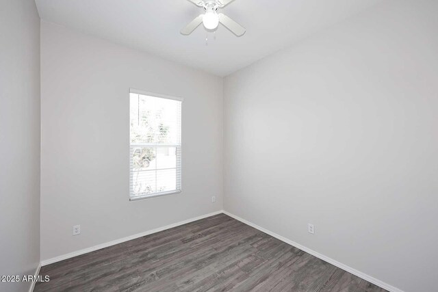 empty room featuring baseboards, ceiling fan, and wood finished floors
