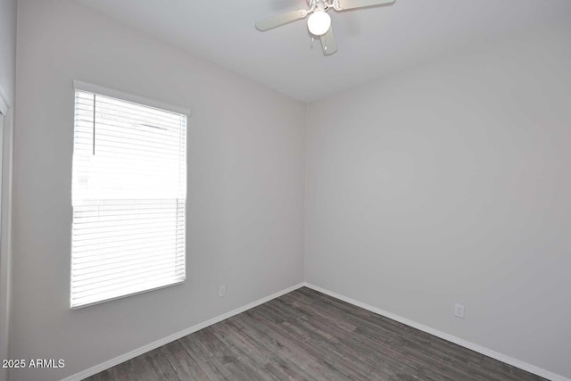empty room featuring a ceiling fan, baseboards, and wood finished floors