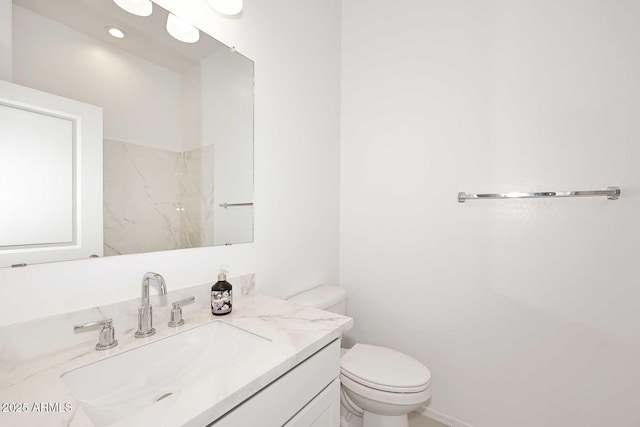bathroom with toilet and vanity
