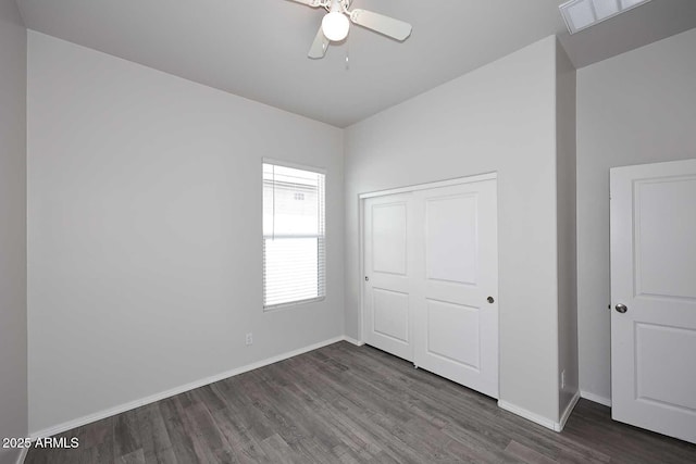 unfurnished bedroom with visible vents, a closet, wood finished floors, baseboards, and ceiling fan
