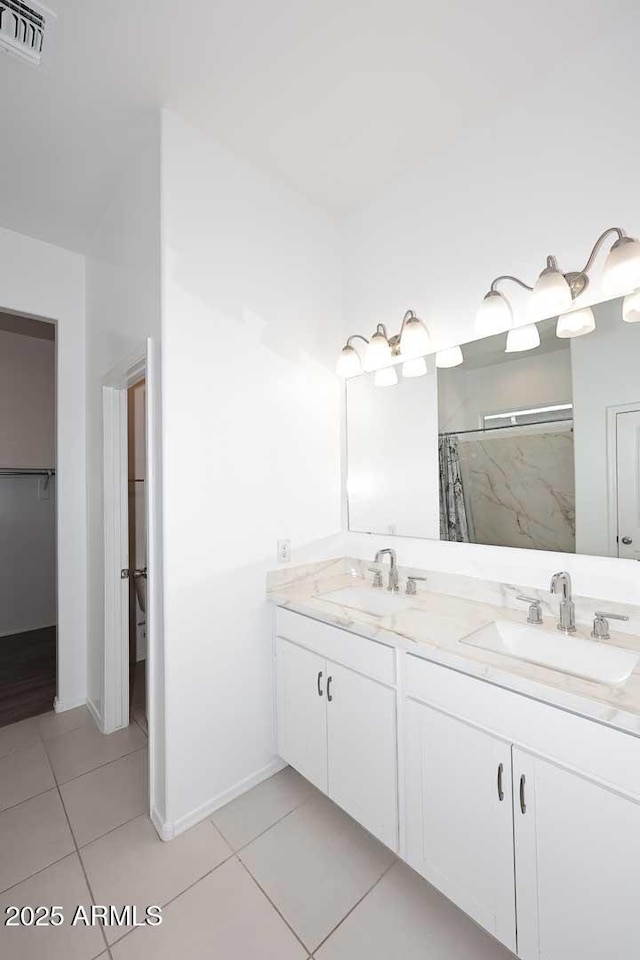 full bathroom featuring visible vents, a sink, tile patterned floors, and double vanity