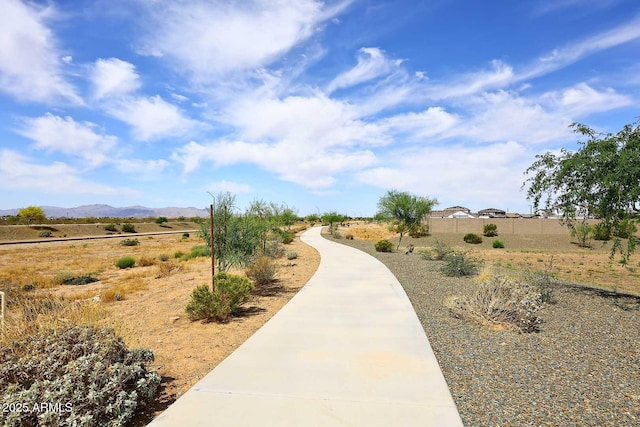 view of property's community featuring a mountain view and fence