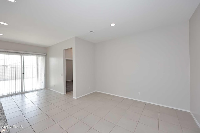 spare room with baseboards, recessed lighting, and light tile patterned floors