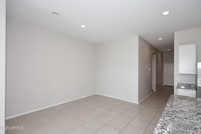 unfurnished room featuring recessed lighting, baseboards, light tile patterned floors, and visible vents