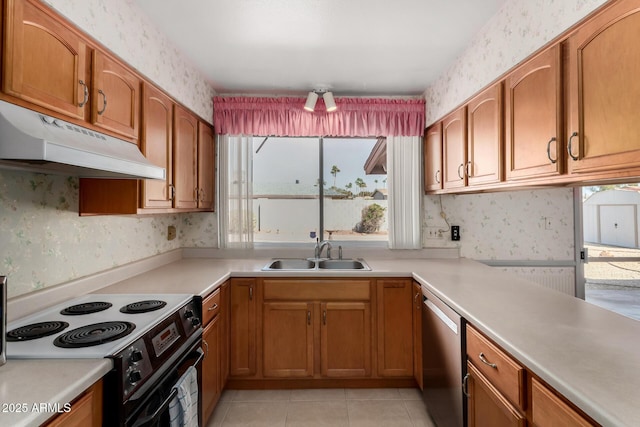 kitchen featuring stainless steel dishwasher, electric range oven, a sink, under cabinet range hood, and wallpapered walls