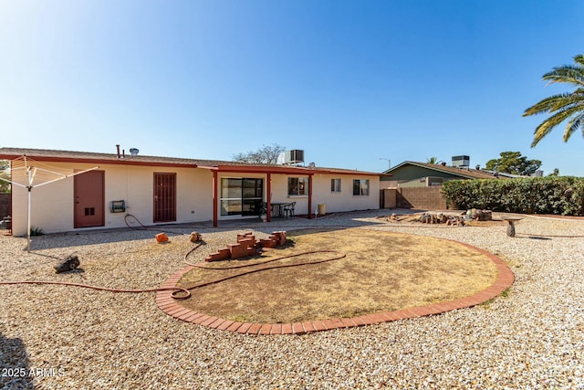 rear view of property featuring a patio area and fence