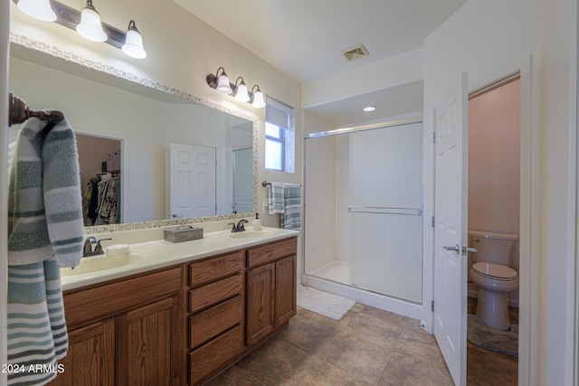 bathroom featuring vanity, toilet, and walk in shower