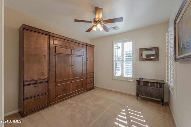 bedroom with light colored carpet and ceiling fan