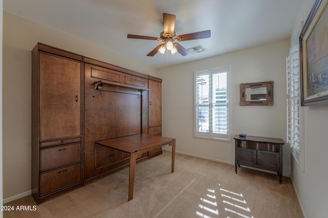 carpeted office space with ceiling fan