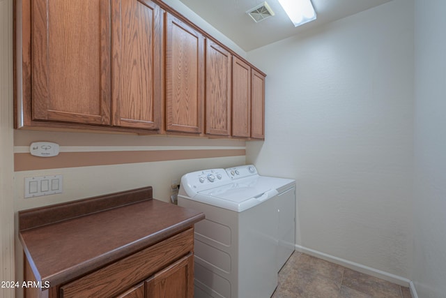 washroom featuring cabinets and washing machine and dryer