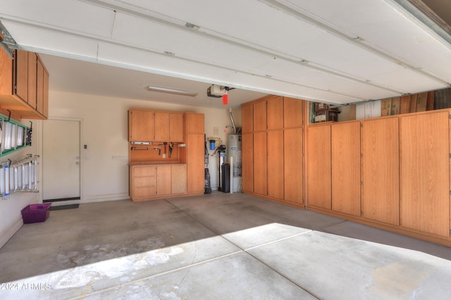 garage featuring water heater and a garage door opener