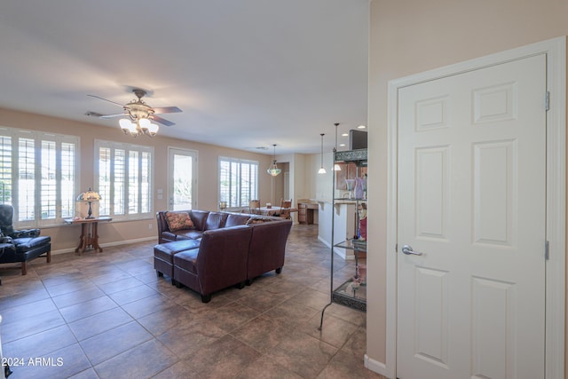 living room featuring dark tile patterned flooring and ceiling fan