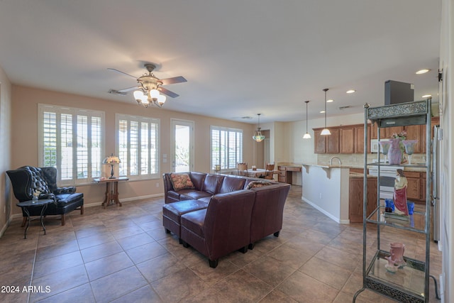 tiled living room featuring ceiling fan