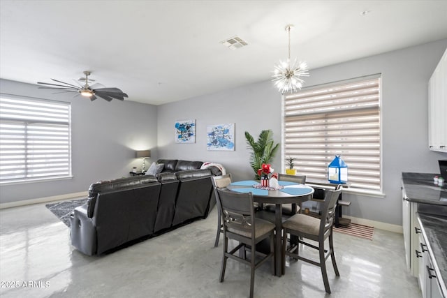 dining area with ceiling fan with notable chandelier