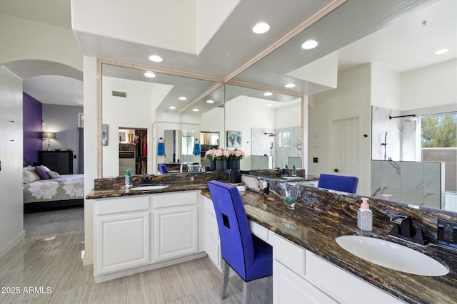 bathroom featuring an enclosed shower and vanity