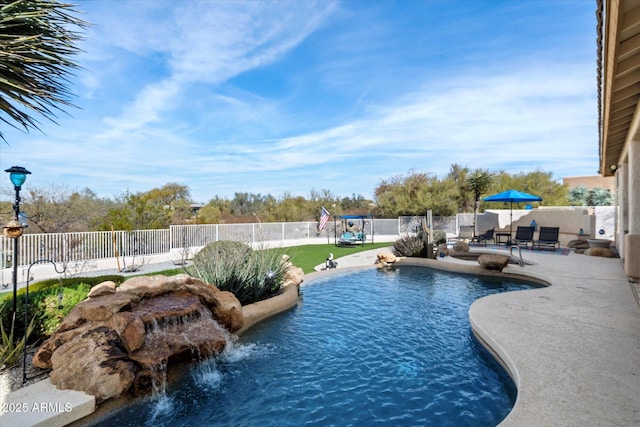 view of pool with a patio and pool water feature