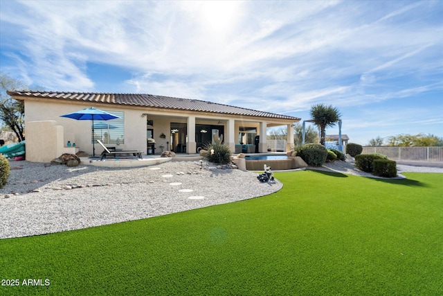 rear view of property featuring a patio and a yard