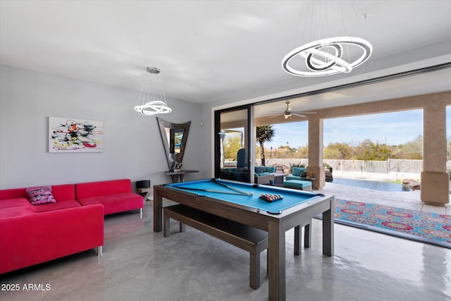 recreation room with pool table, concrete floors, and a notable chandelier