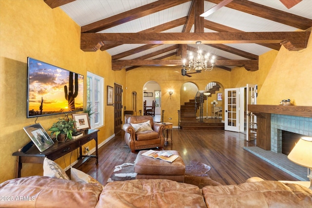 1614 Palmcroft Dr SW, Phoenix, AZ 85007 - living area featuring a tiled fireplace, wood finished floors, arched walkways, baseboards, and stairs