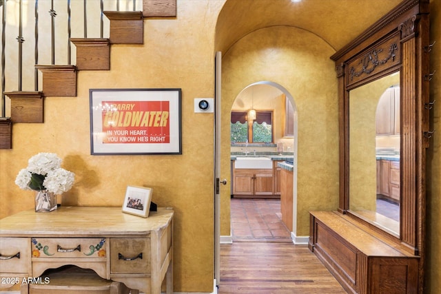 1614 Palmcroft Dr SW, Phoenix, AZ 85007 - hallway featuring a sink, arched walkways, lofted ceiling, and wood finished floors