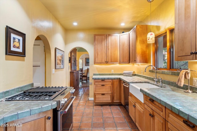 1614 Palmcroft Dr SW, Phoenix, AZ 85007 - kitchen featuring tile countertops, stainless steel appliances, decorative light fixtures, and a sink