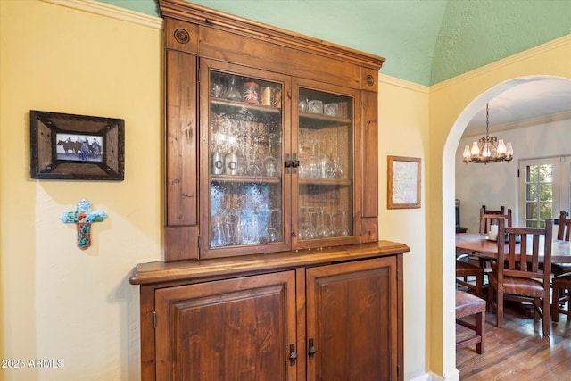 1614 Palmcroft Dr SW, Phoenix, AZ 85007 - details featuring a notable chandelier, wood finished floors, arched walkways, and ornamental molding