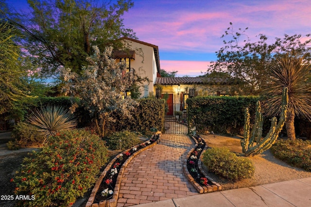 1614 Palmcroft Dr SW, Phoenix, AZ 85007 - yard at dusk featuring a fenced front yard and a gate