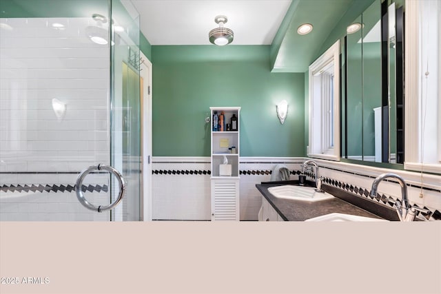 1614 Palmcroft Dr SW, Phoenix, AZ 85007 - full bathroom featuring wainscoting, a stall shower, tile walls, and a sink