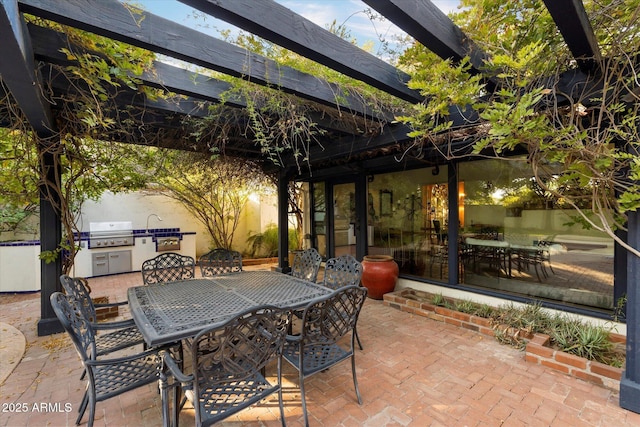1614 Palmcroft Dr SW, Phoenix, AZ 85007 - view of patio / terrace with glass enclosure, an outdoor kitchen, area for grilling, and outdoor dining space