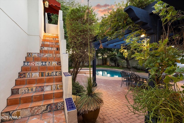 1614 Palmcroft Dr SW, Phoenix, AZ 85007 - pool at dusk featuring a patio area, a fenced in pool, and a pergola