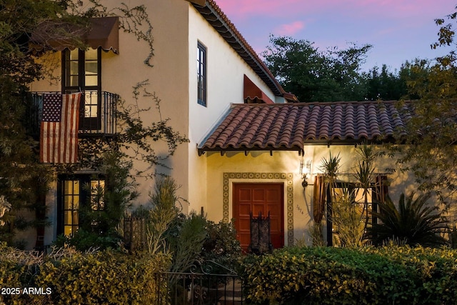 1614 Palmcroft Dr SW, Phoenix, AZ 85007 - exterior entry at dusk featuring a tiled roof and stucco siding