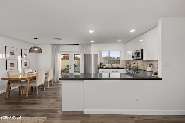 kitchen with white cabinetry, dark countertops, stainless steel appliances, recessed lighting, and french doors
