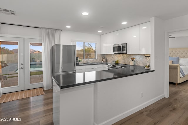 kitchen featuring a sink, french doors, stainless steel appliances, and visible vents