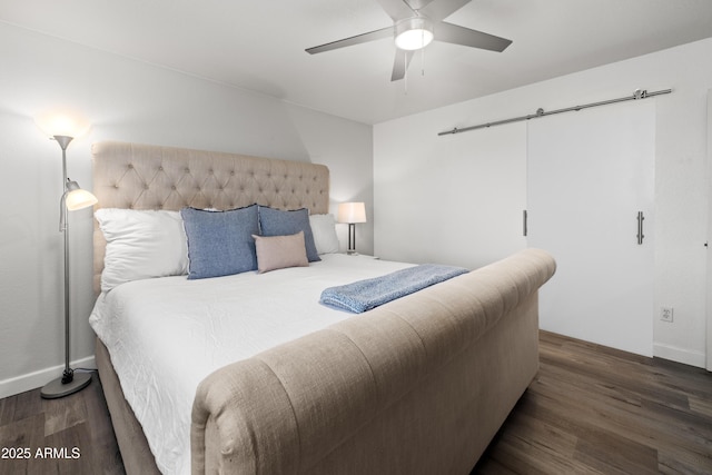 bedroom featuring baseboards, wood finished floors, and a ceiling fan