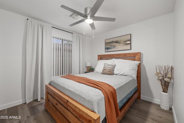 bedroom featuring baseboards, visible vents, wood finished floors, and ceiling fan