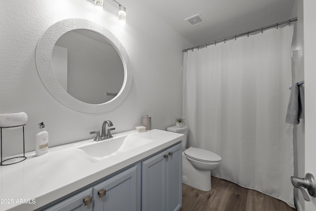 full bath featuring wood finished floors, visible vents, toilet, and vanity