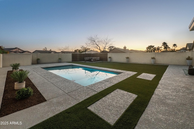 view of swimming pool featuring a fenced in pool, a patio area, a yard, and a fenced backyard